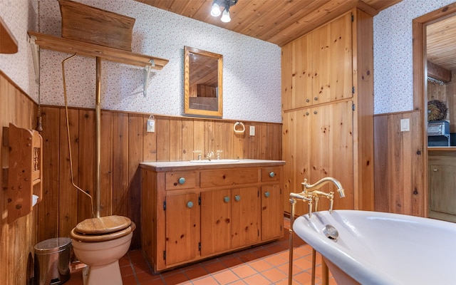 1298 E Mountain Meadow Rd, Kalispell, MT 59901 - bathroom with a wainscoted wall, wallpapered walls, wood walls, and tile patterned floors