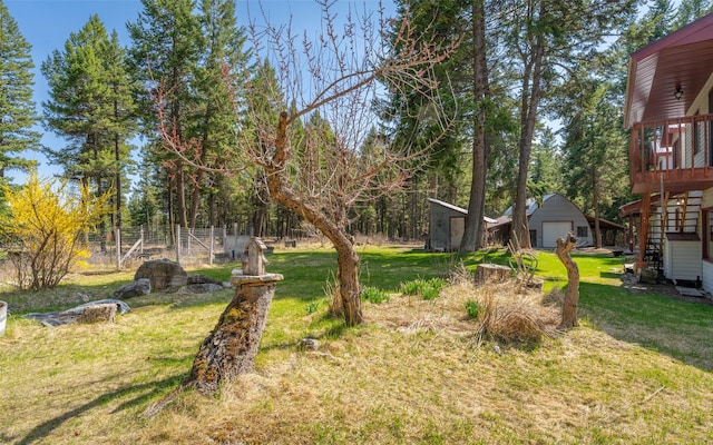 1298 E Mountain Meadow Rd, Kalispell, MT 59901 - view of yard with a garage, an outbuilding, stairs, and a wooden deck