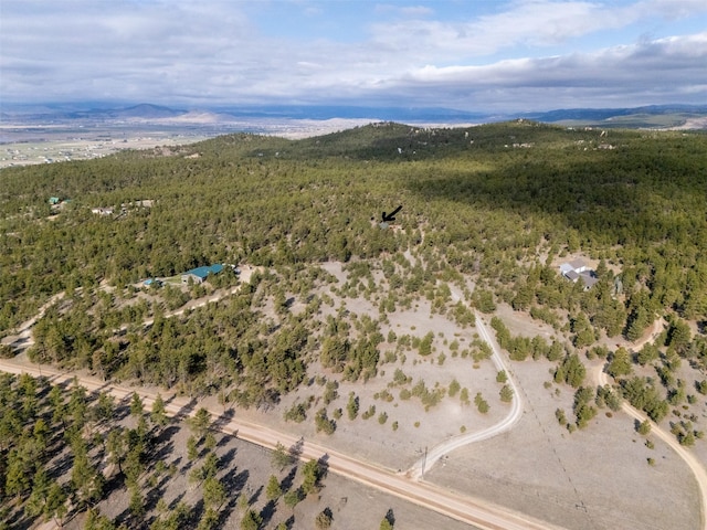 aerial view with a wooded view and a mountain view
