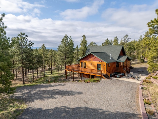 view of front of property with log veneer siding and a wooden deck