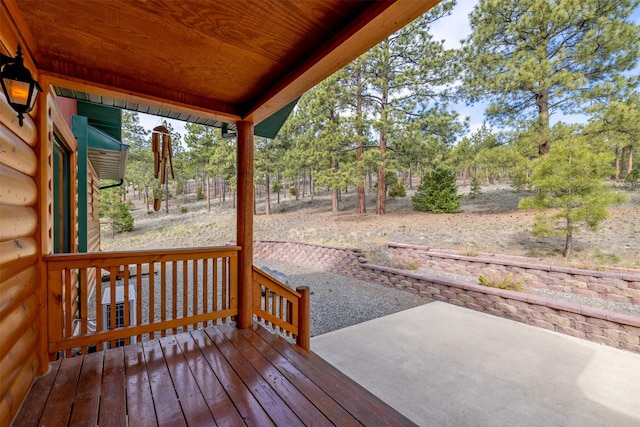 wooden terrace with a patio area