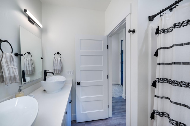 1347 Lake Pointe Dr, Bigfork, MT 59911 - bathroom featuring wood finished floors and double vanity