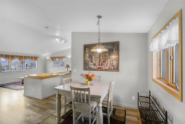 3404 Jasper Rd, Great Falls, MT 59404 - dining area with rail lighting, wood finished floors, and vaulted ceiling