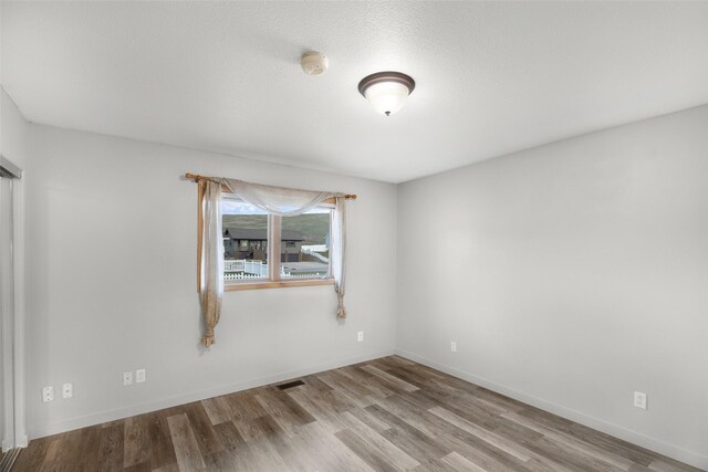 3404 Jasper Rd, Great Falls, MT 59404 - spare room with wood finished floors and a smoke detector