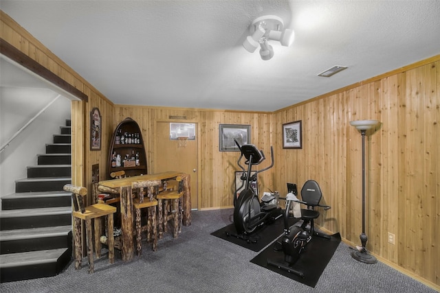 3404 Jasper Rd, Great Falls, MT 59404 - workout room featuring wooden walls, carpet flooring, and a textured ceiling