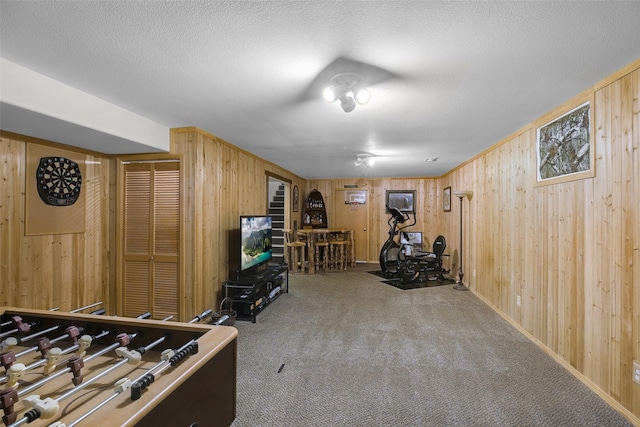 3404 Jasper Rd, Great Falls, MT 59404 - playroom with wood walls, carpet flooring, and a textured ceiling