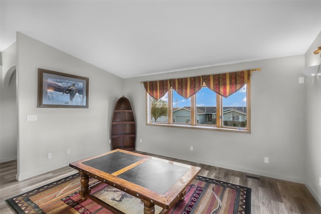 3404 Jasper Rd, Great Falls, MT 59404 - sitting room with wood finished floors, arched walkways, and vaulted ceiling