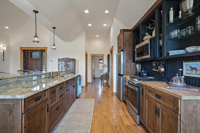 160 Jackson Creek Rd, Clancy, MT 59634 - kitchen featuring appliances with stainless steel finishes, open shelves, light wood-type flooring, pendant lighting, and high vaulted ceiling