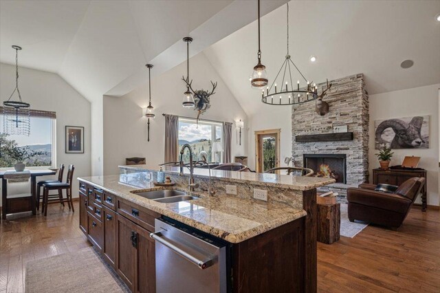 160 Jackson Creek Rd, Clancy, MT 59634 - kitchen featuring stainless steel dishwasher, open floor plan, dark wood-style flooring, a stone fireplace, and high vaulted ceiling