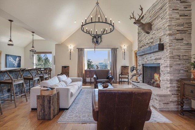 160 Jackson Creek Rd, Clancy, MT 59634 - living area featuring high vaulted ceiling, wood finished floors, a chandelier, and a fireplace