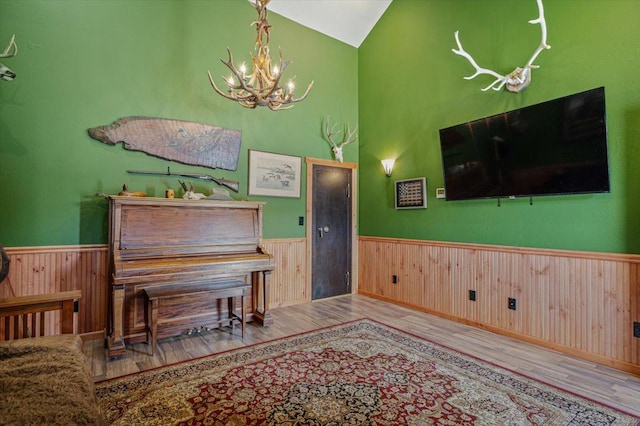 160 Jackson Creek Rd, Clancy, MT 59634 - sitting room with wood finished floors, a chandelier, wainscoting, wooden walls, and high vaulted ceiling
