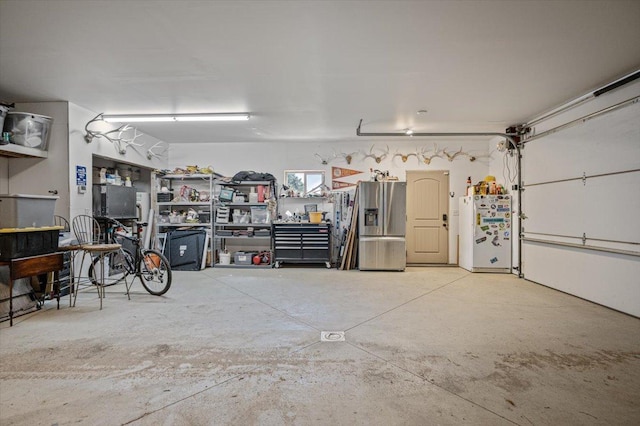 160 Jackson Creek Rd, Clancy, MT 59634 - garage with freestanding refrigerator and stainless steel refrigerator with ice dispenser