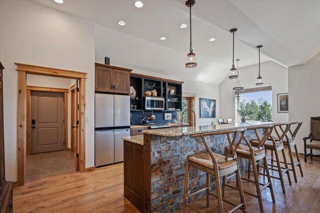 160 Jackson Creek Rd, Clancy, MT 59634 - kitchen with appliances with stainless steel finishes, recessed lighting, light wood-type flooring, open shelves, and vaulted ceiling
