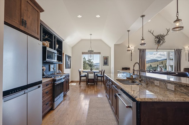 160 Jackson Creek Rd, Clancy, MT 59634 - kitchen with appliances with stainless steel finishes, vaulted ceiling, pendant lighting, light wood-style floors, and light stone counters