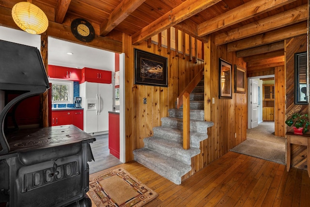 1085 K M Ranch Rd, Whitefish, MT 59937 - staircase featuring beam ceiling, wooden ceiling, hardwood / wood-style floors, and wood walls