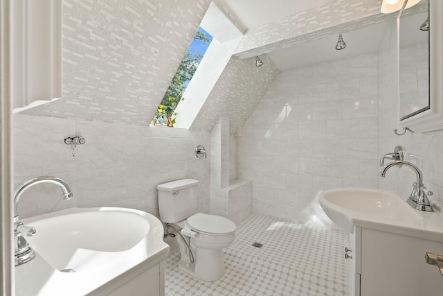 1085 K M Ranch Rd, Whitefish, MT 59937 - full bathroom featuring tile walls, tiled shower, vanity, toilet, and a skylight