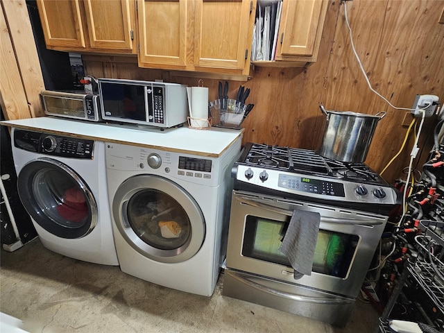 clothes washing area with independent washer and dryer and laundry area