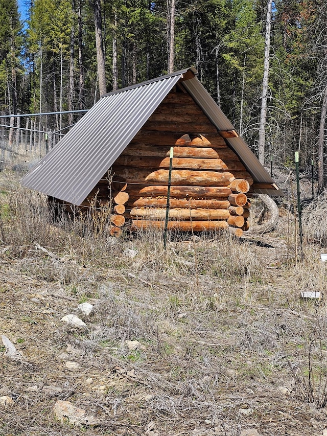 view of outdoor structure featuring a wooded view