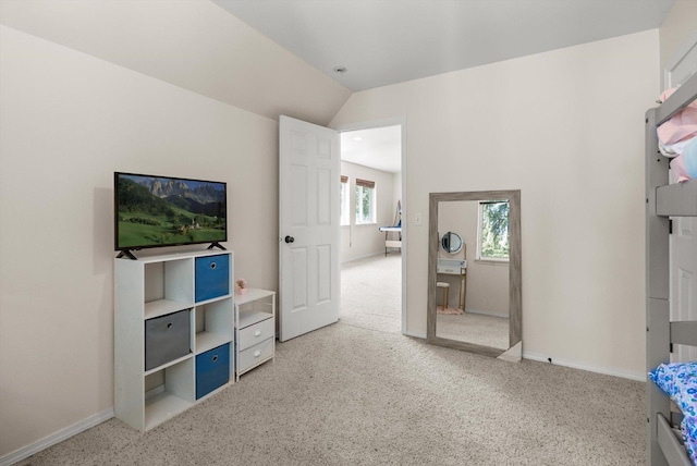 116 Grandview Ter, Lakeside, MT 59922 - unfurnished bedroom with vaulted ceiling, baseboards, and light carpet