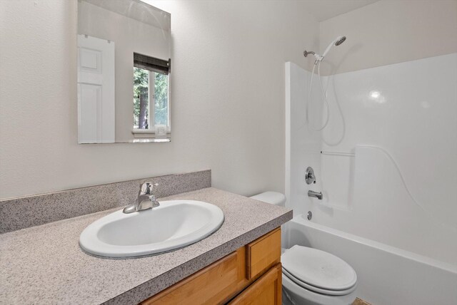 full bath featuring bathing tub / shower combination, toilet, and vanity