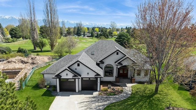 14 Buffalo Hill Cir, Kalispell, MT 59901 - view of front facade with a front lawn, concrete driveway, a garage, and a shingled roof