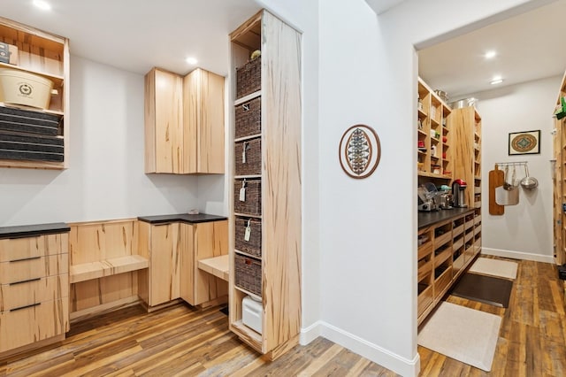 14 Buffalo Hill Cir, Kalispell, MT 59901 - kitchen with light brown cabinets, light wood-type flooring, recessed lighting, baseboards, and dark countertops