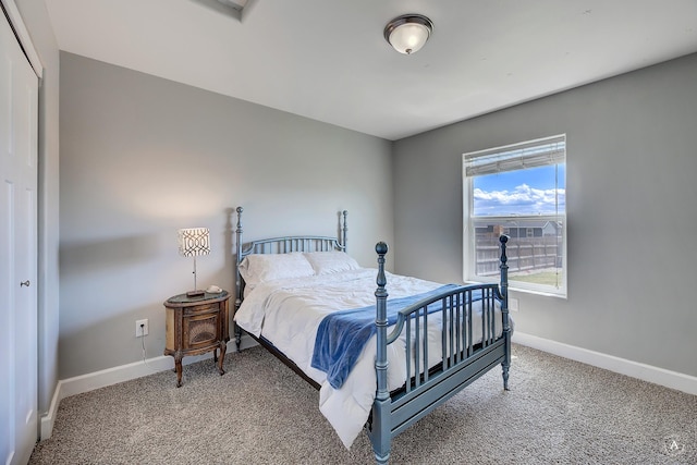 bedroom with baseboards and light colored carpet