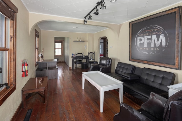 916 2nd St E, Whitefish, MT 59937 - living area with arched walkways, hardwood / wood-style floors, rail lighting, and ornamental molding