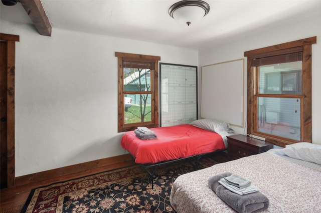 916 2nd St E, Whitefish, MT 59937 - bedroom featuring beam ceiling and wood finished floors