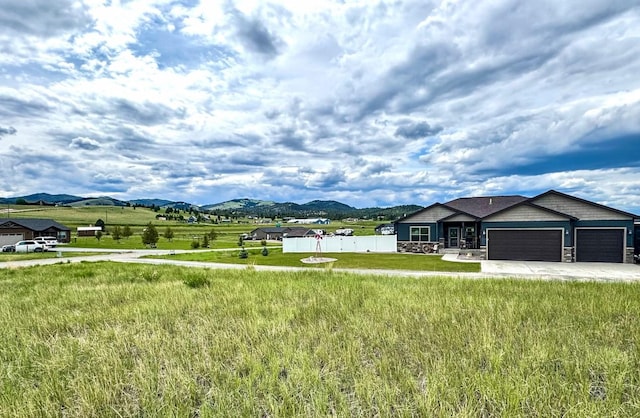 19 Country Meadow Ln, Clancy, MT 59634 - view of yard with an attached garage, driveway, and a mountain view