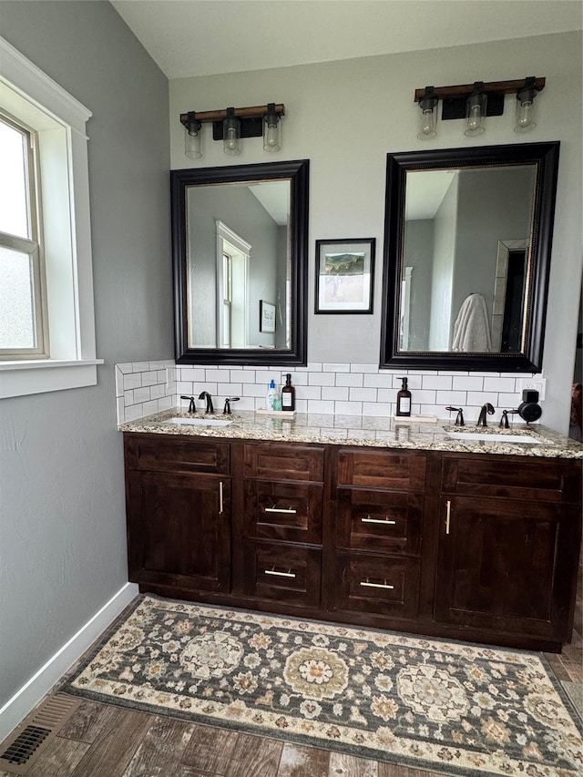 19 Country Meadow Ln, Clancy, MT 59634 - full bath with double vanity, decorative backsplash, and wood finished floors