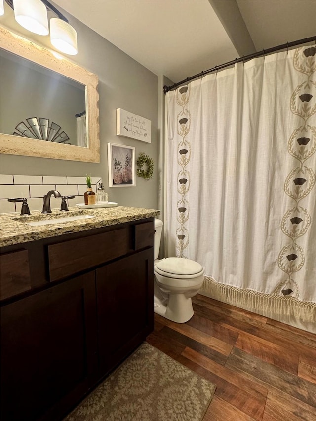 19 Country Meadow Ln, Clancy, MT 59634 - full bathroom featuring decorative backsplash, vanity, and wood finished floors