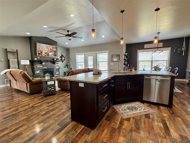 19 Country Meadow Ln, Clancy, MT 59634 - kitchen with stainless steel dishwasher, dark wood-type flooring, a fireplace, healthy amount of natural light, and vaulted ceiling