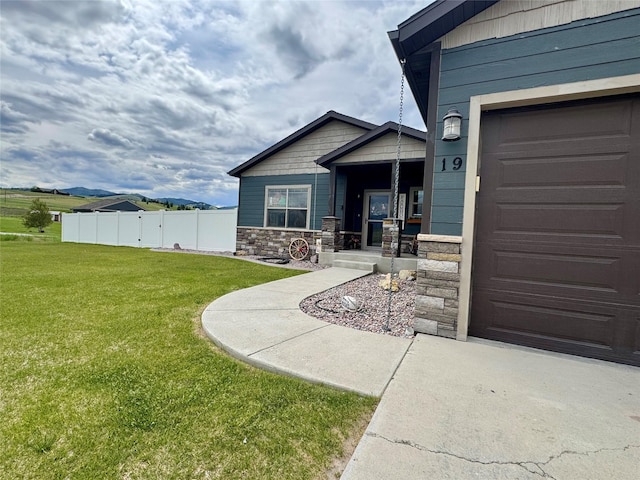 19 Country Meadow Ln, Clancy, MT 59634 - doorway to property featuring stone siding and a garage