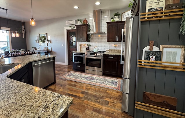 19 Country Meadow Ln, Clancy, MT 59634 - kitchen featuring stainless steel appliances, wall chimney exhaust hood, dark wood-style floors, light stone counters, and dark brown cabinets