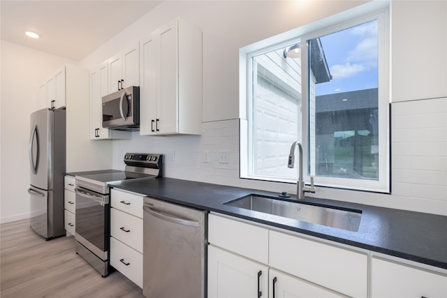 209 Pearl St, Ennis, MT 59729 - kitchen featuring stainless steel appliances, a sink, healthy amount of natural light, dark countertops, and recessed lighting