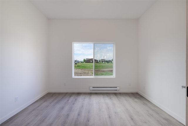 209 Pearl St, Ennis, MT 59729 - unfurnished room with baseboard heating, light wood-type flooring, and baseboards