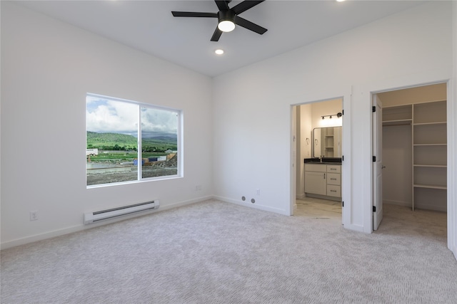 209 Pearl St, Ennis, MT 59729 - unfurnished bedroom featuring baseboard heating, light colored carpet, a spacious closet, recessed lighting, and baseboards