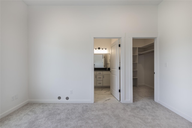 209 Pearl St, Ennis, MT 59729 - unfurnished bedroom with a spacious closet, light colored carpet, baseboards, and a closet