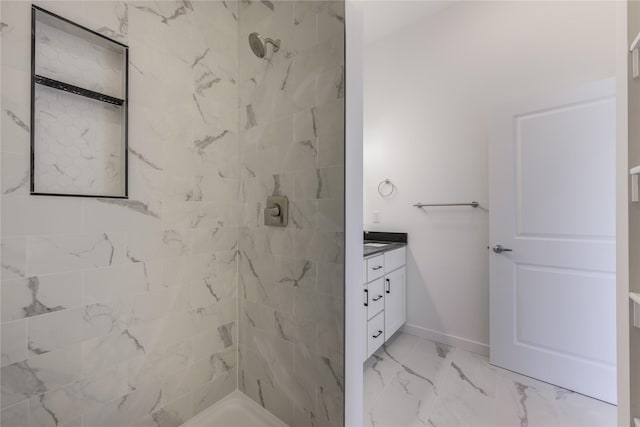 209 Pearl St, Ennis, MT 59729 - full bathroom featuring a tile shower, marble look tile flooring, vanity, and baseboards