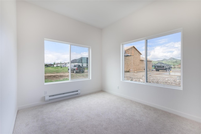 209 Pearl St, Ennis, MT 59729 - carpeted empty room featuring a baseboard heating unit and baseboards