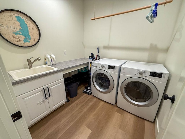 123 Owl Loop, Kalispell, MT 59901 - washroom with independent washer and dryer, cabinet space, light wood finished floors, and a sink