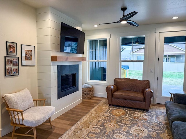 123 Owl Loop, Kalispell, MT 59901 - living room with baseboards, a tile fireplace, recessed lighting, wood finished floors, and a ceiling fan