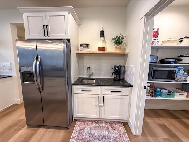 123 Owl Loop, Kalispell, MT 59901 - kitchen with appliances with stainless steel finishes, white cabinetry, open shelves, and light wood finished floors