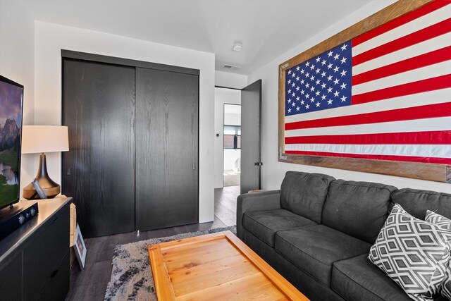 living room featuring visible vents and wood finished floors