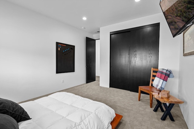 bedroom with recessed lighting, a closet, and carpet flooring