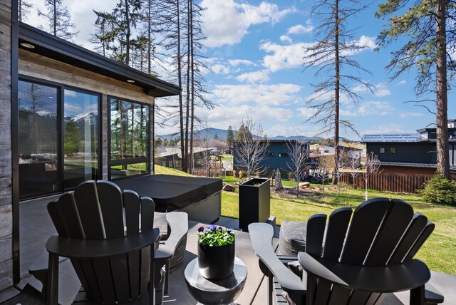 view of patio / terrace with a mountain view and fence