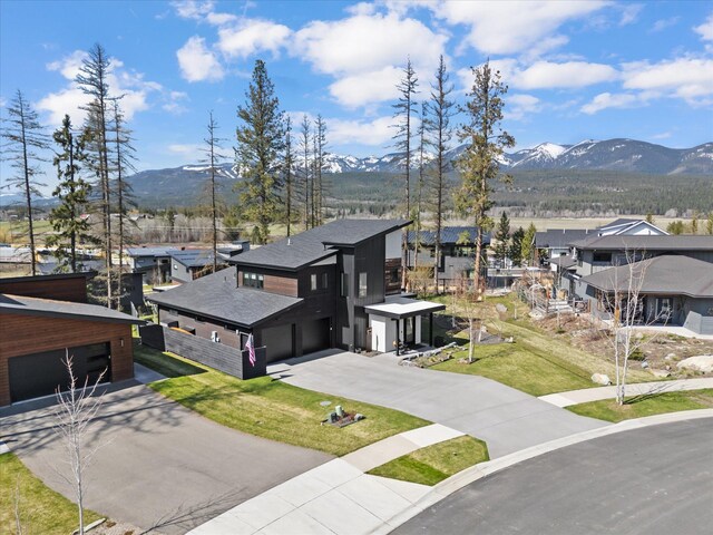 birds eye view of property with a mountain view and a residential view