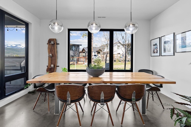 dining space with finished concrete flooring and visible vents