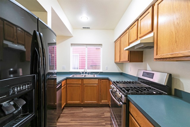 1312 Bridgecourt Way, Missoula, MT 59801 - kitchen featuring appliances with stainless steel finishes, under cabinet range hood, a sink, and dark countertops